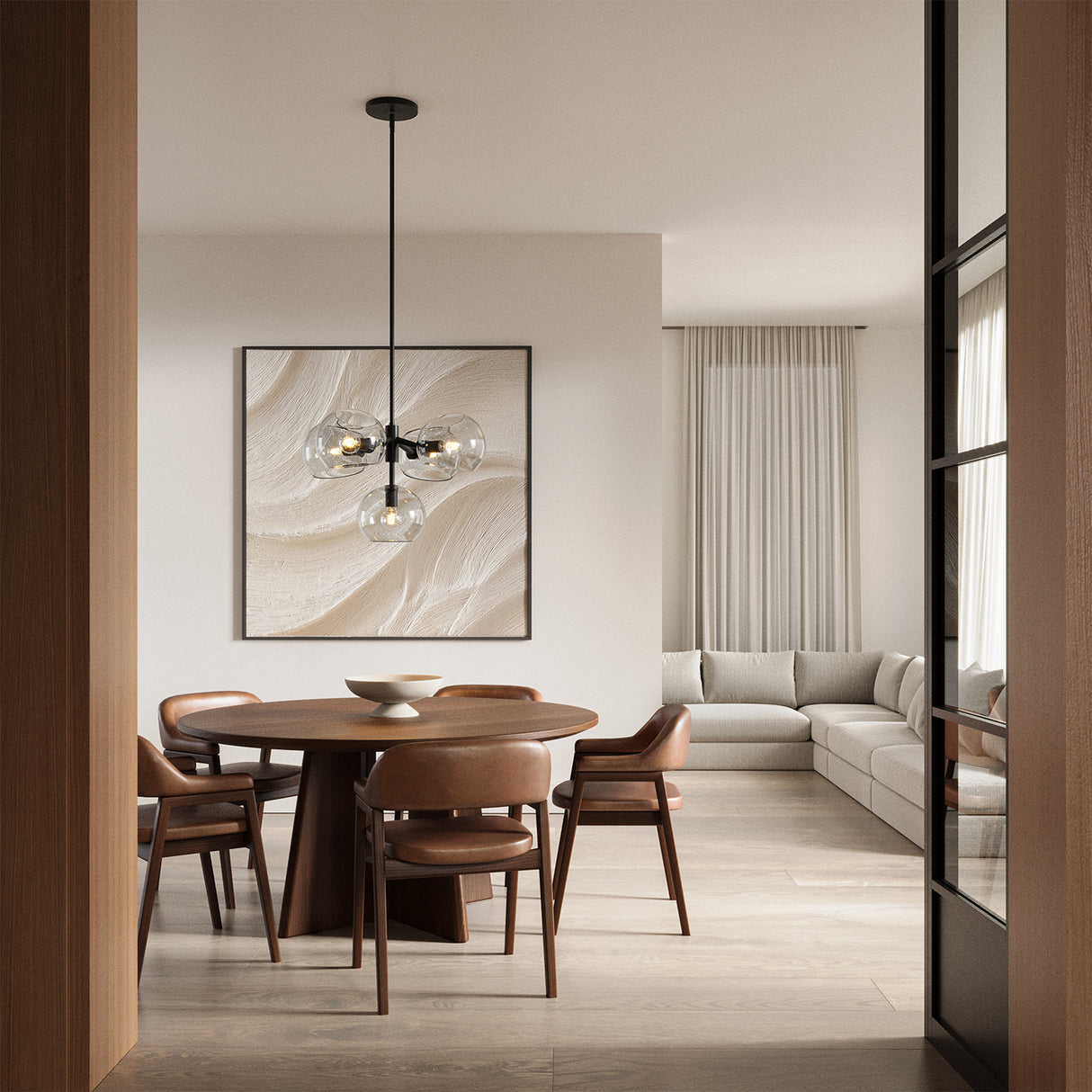 A chic dining room featuring the Flynn 5 Light Pendant in Matte Black with Clear Glass hung above a round wooden dining table with seating for five.
