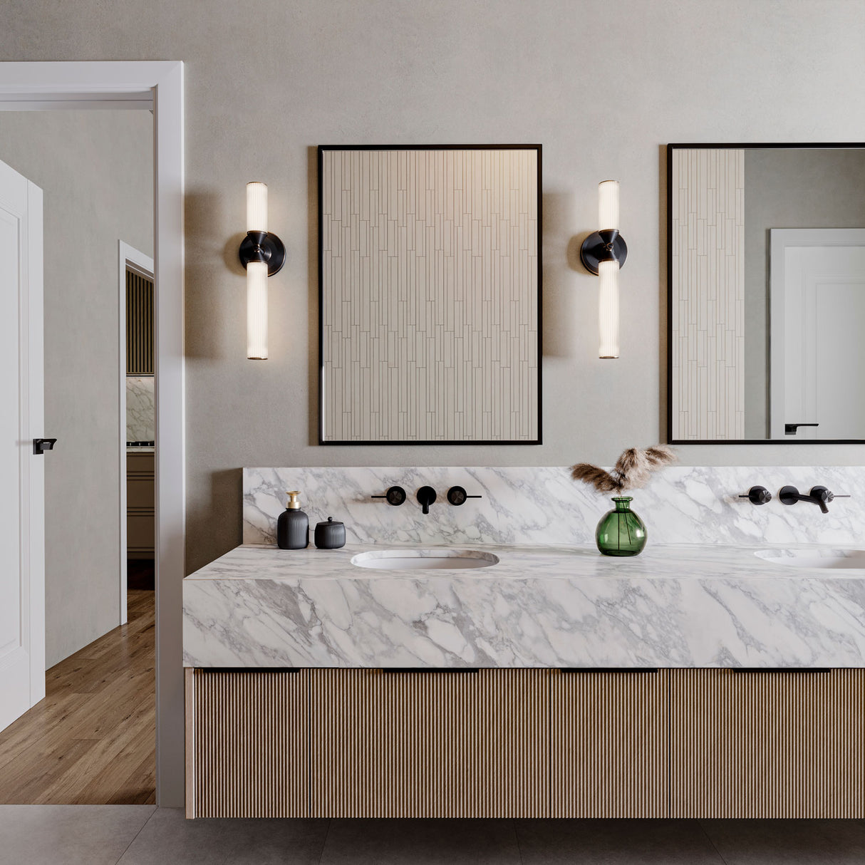 Blain 18" LED wall sconce shown next to two modern black vanity mirrors in a primary bathroom.