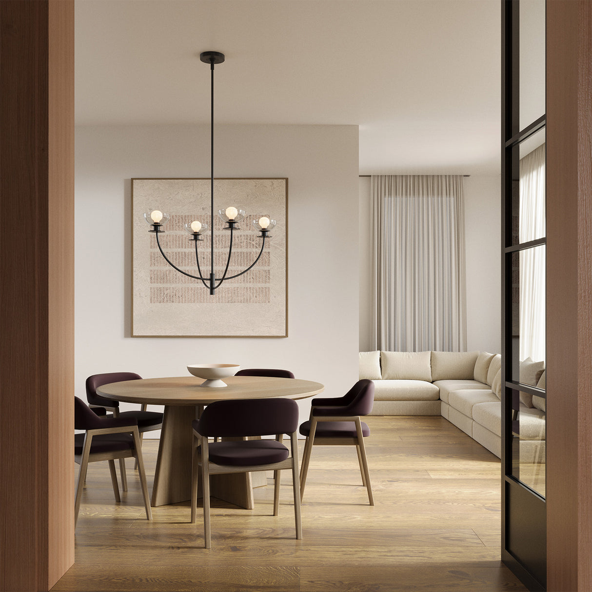 Open-concept, modern dining room with a round table for five, and the Bella 4 Light Chandelier in  Matte Black.