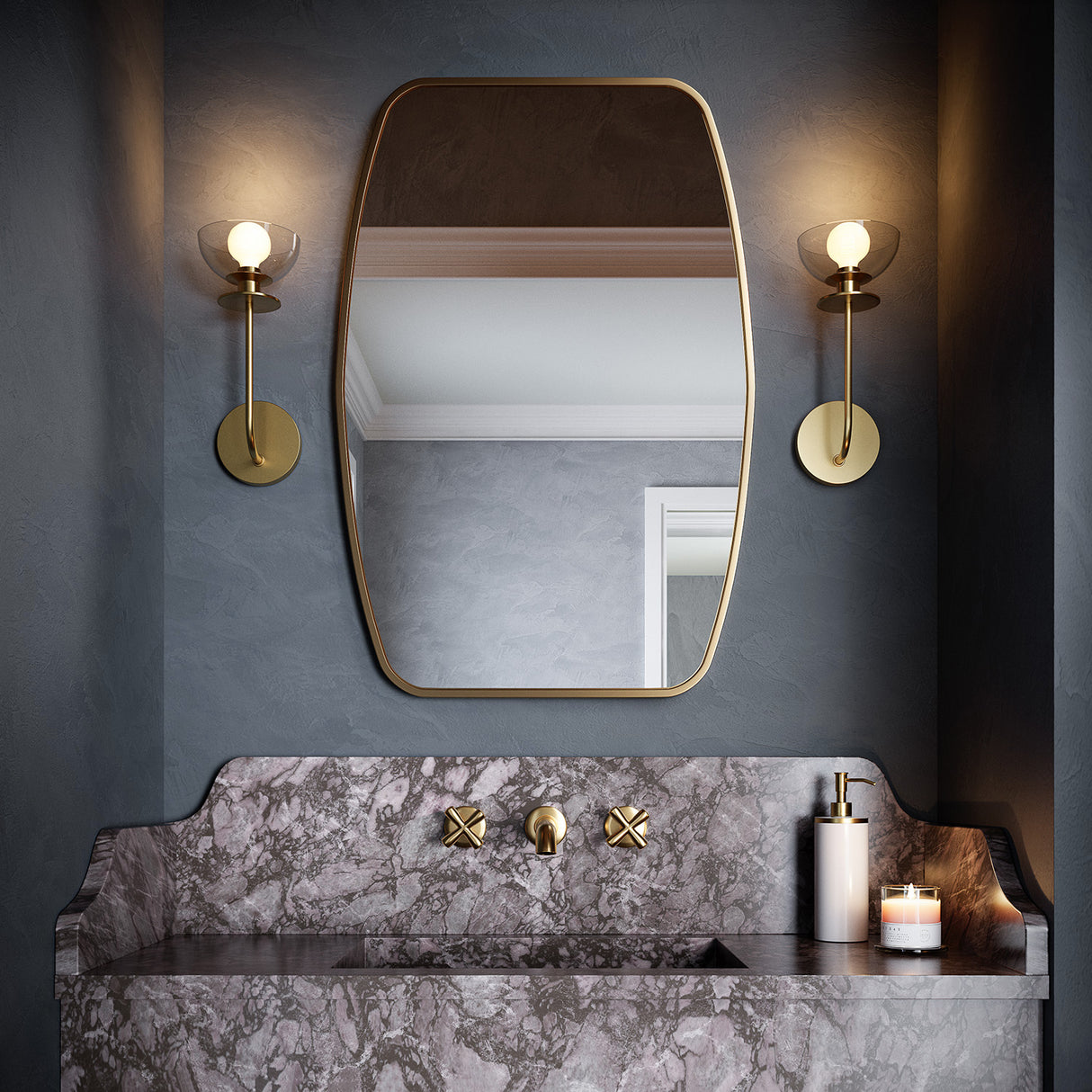 Two Bella wall sconces in brass, shown flanking a powder room mirror, with blue-grey venetian plaster walls and a marble slab sink.