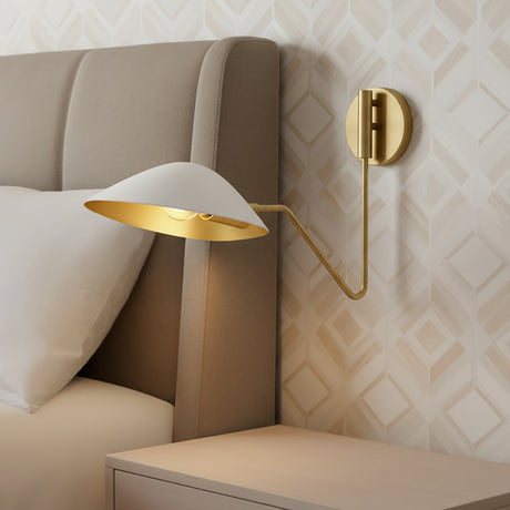 Jade Swing Arm Sconce, White and Antique Brass finish, shown as a bedside reading light in a bedroom with geometric wallpaper.