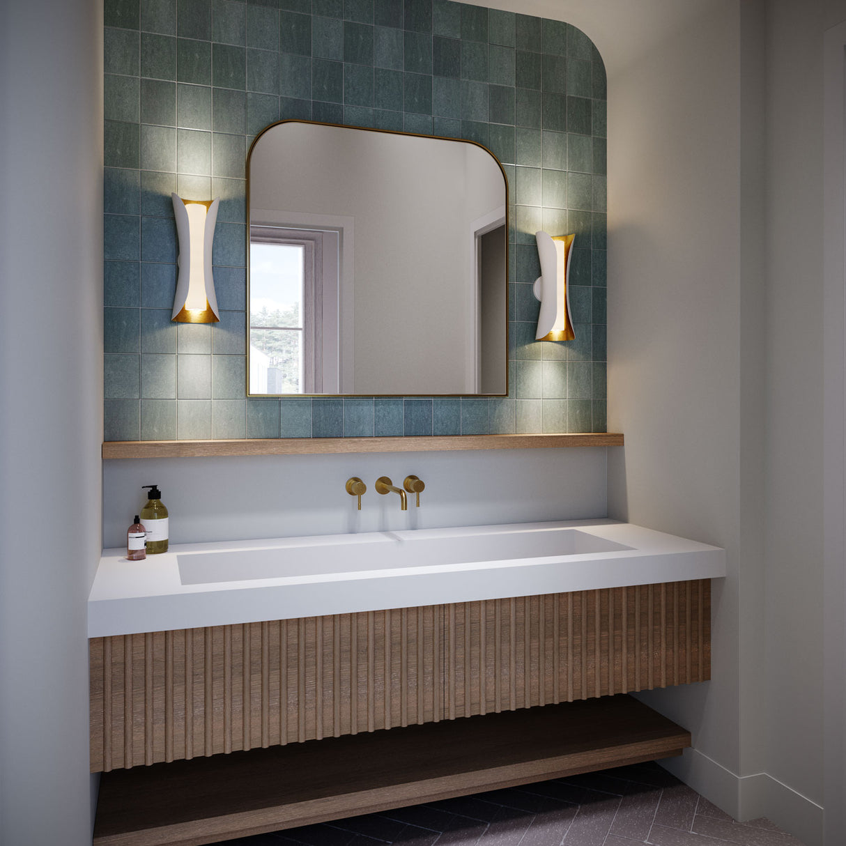 Rhys Wall Sconce in white with gold shown with teal tile backsplash and a large white vanity sink.