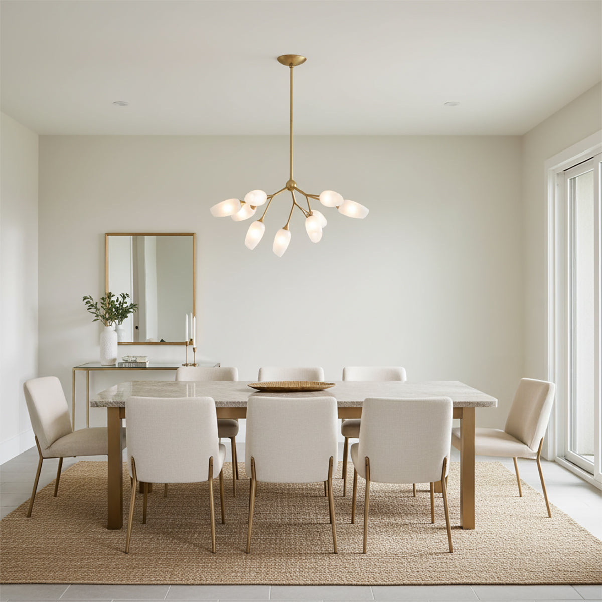 Amara 9 Light Chandelier 34 - A contemporary dining room featuring a gold leaf chandelier with art glass shades, a marble-top dining table with upholstered chairs, and a gold-framed mirror.