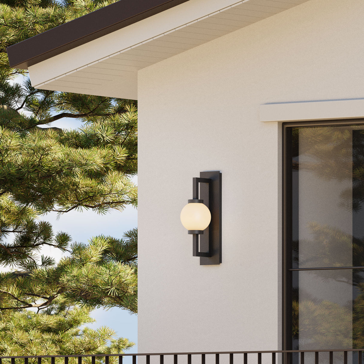 Gus medium 19" outdoor wall light, a globe style modern porch light, is shown on a white stucco house in the Pacific North West.