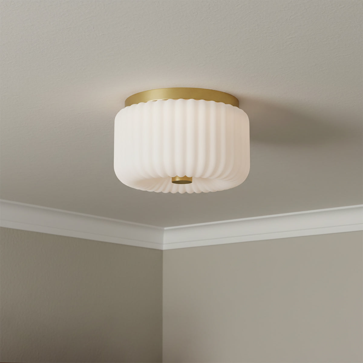 Dora Flush Mount 10, Aged Brass with Opal Glass - Flush mount light with a ribbed opal glass shade and aged brass accents affixed to a white ceiling.