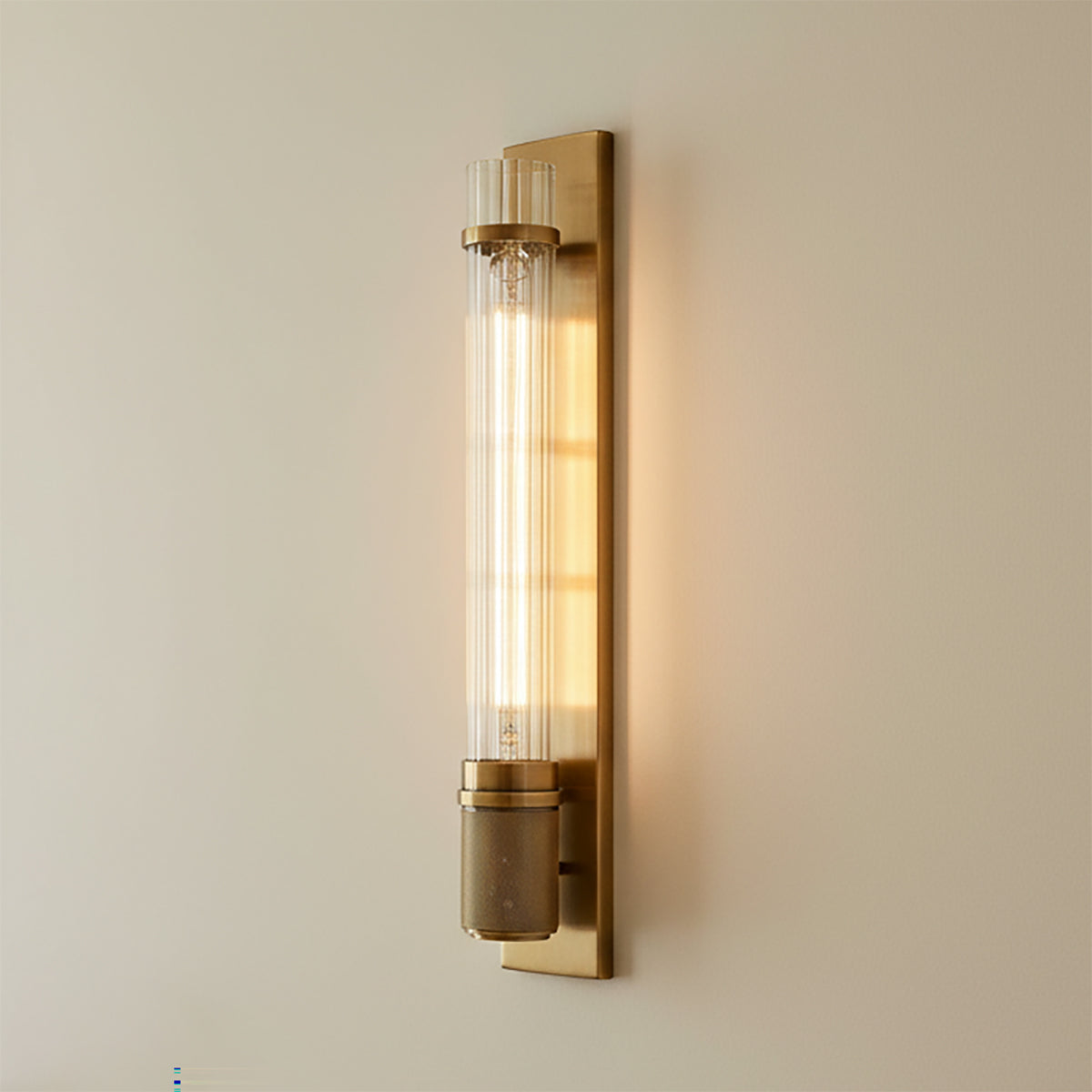Zeke Wall Sconce 16, Aged Brass - Close up of brass wall sconce with clear glass shade