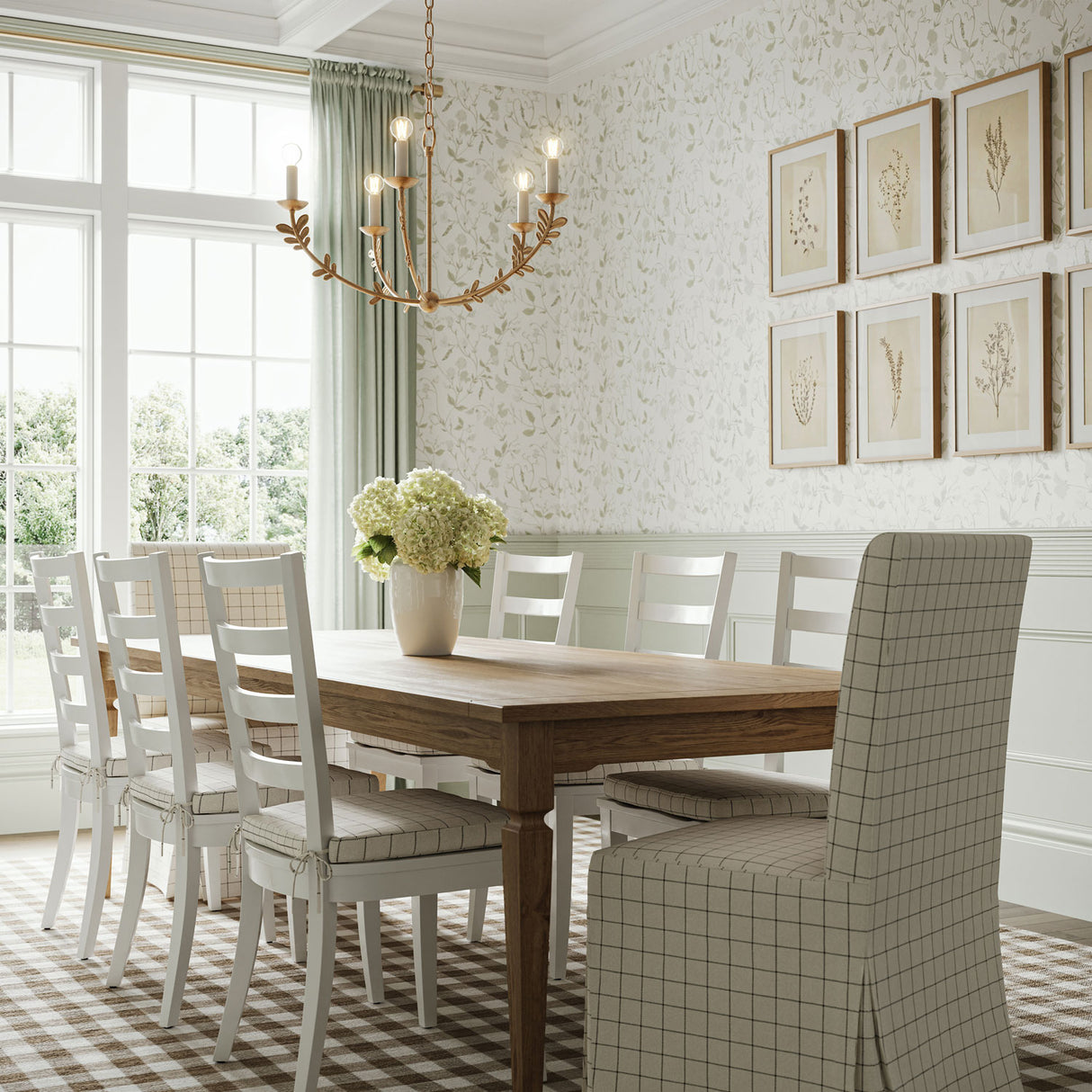 Aviva 5 Light Chandelier in Gold leaf finish, shown in a country inspired dining room with a farmer table, botanical wall paper, and sage green accents.
