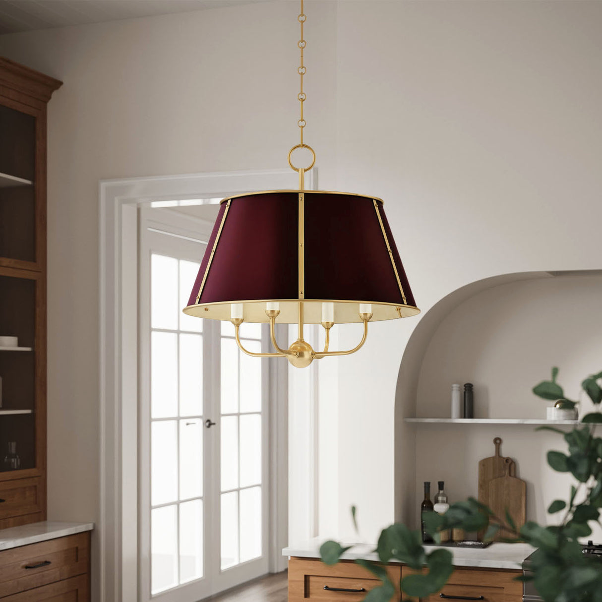 Avery 4 Light Large 20" Pendant light with a burgundy shade and brass detailing is hung in a kitchen with cream walls and oak cabinets.