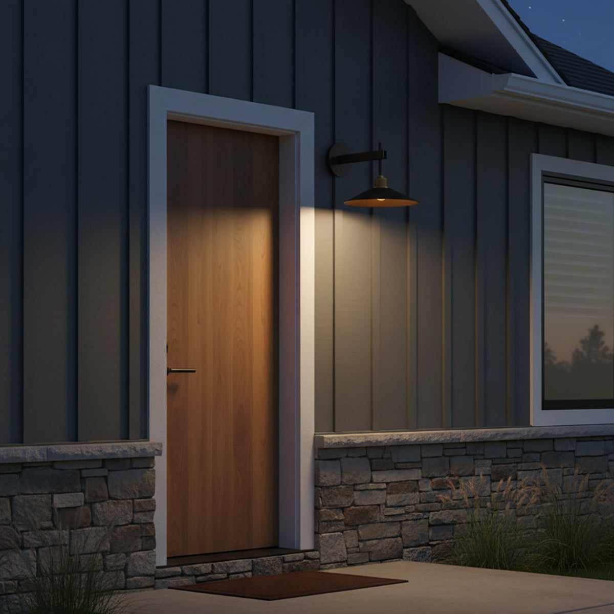 Emeri LED Outdoor Wall Light, Small Bronze with Vintage Brass Accents - Exterior view of a wood door illuminated by a wall sconce at dusk