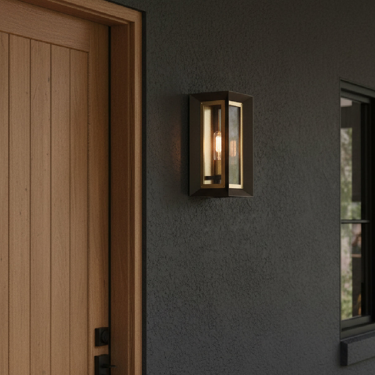 Wesley Small 14" tall outdoor light fixture on a dark gray wall next to a wooden door.
