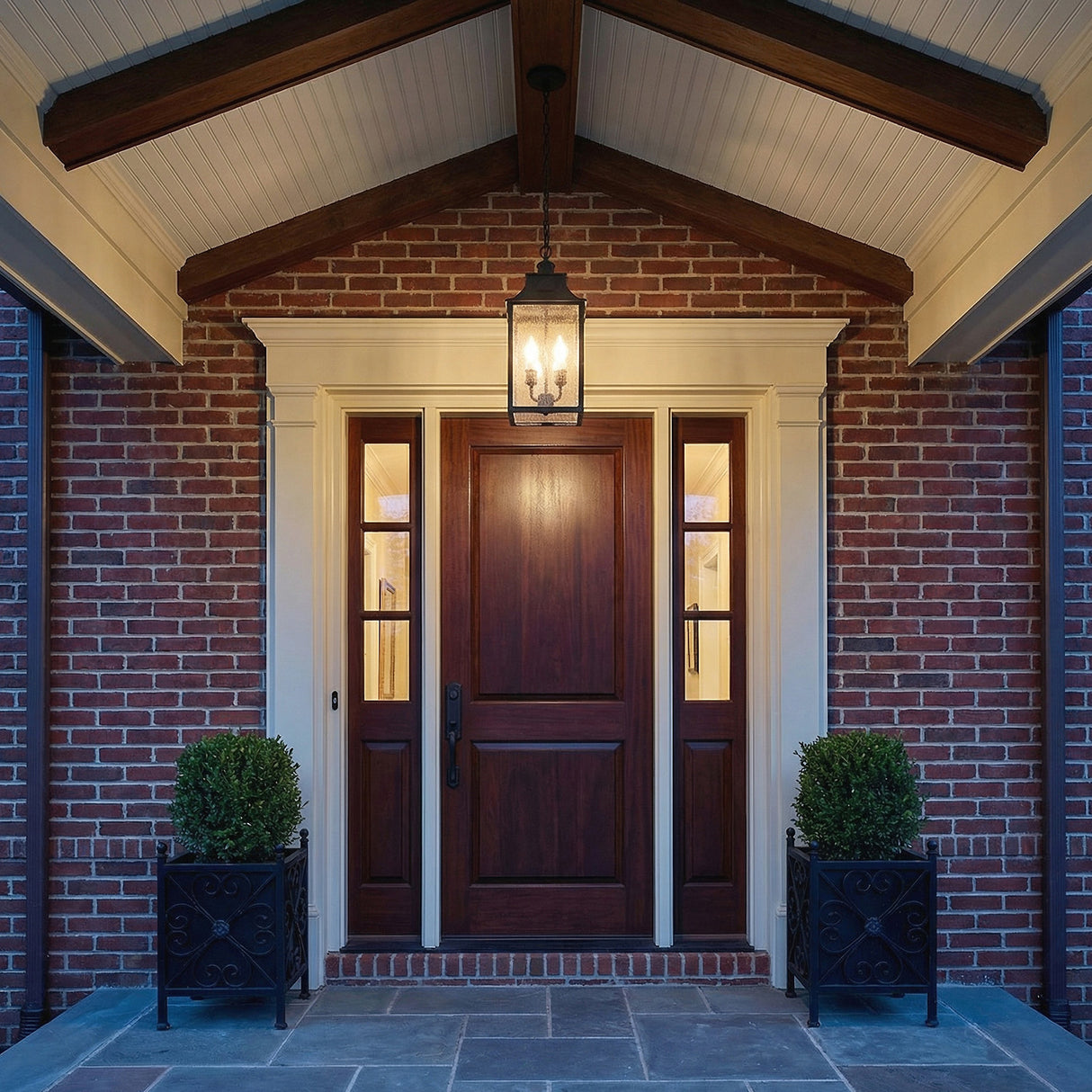 Bedford Outdoor Hanging Light, Antique Black Iron geometric Outdoor Hanging in a Colonial Outdoor with a dark wood door and brick walls.