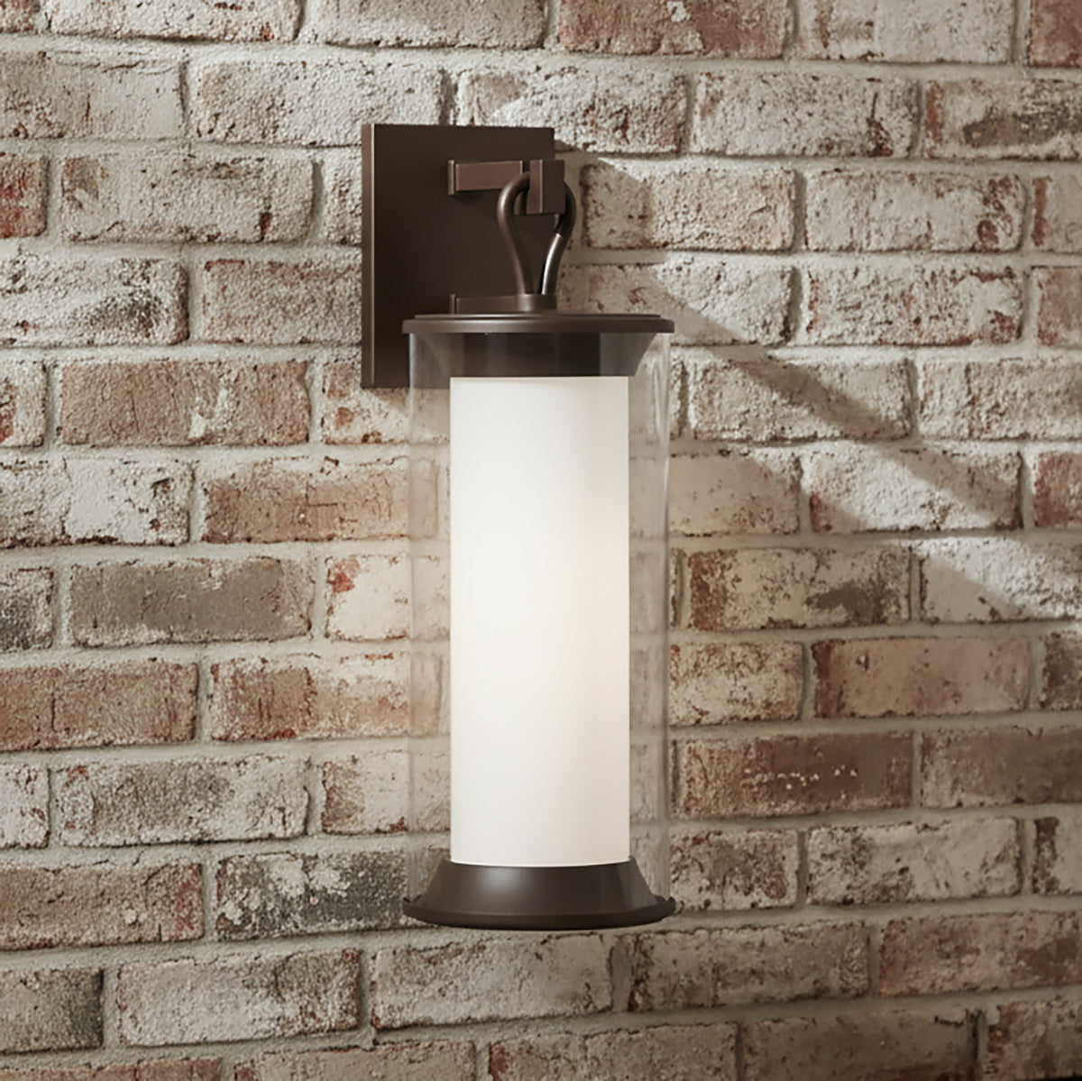 Halsey Outdoor 18" tall Wall Light in bronze finish, shown on a brick wall.