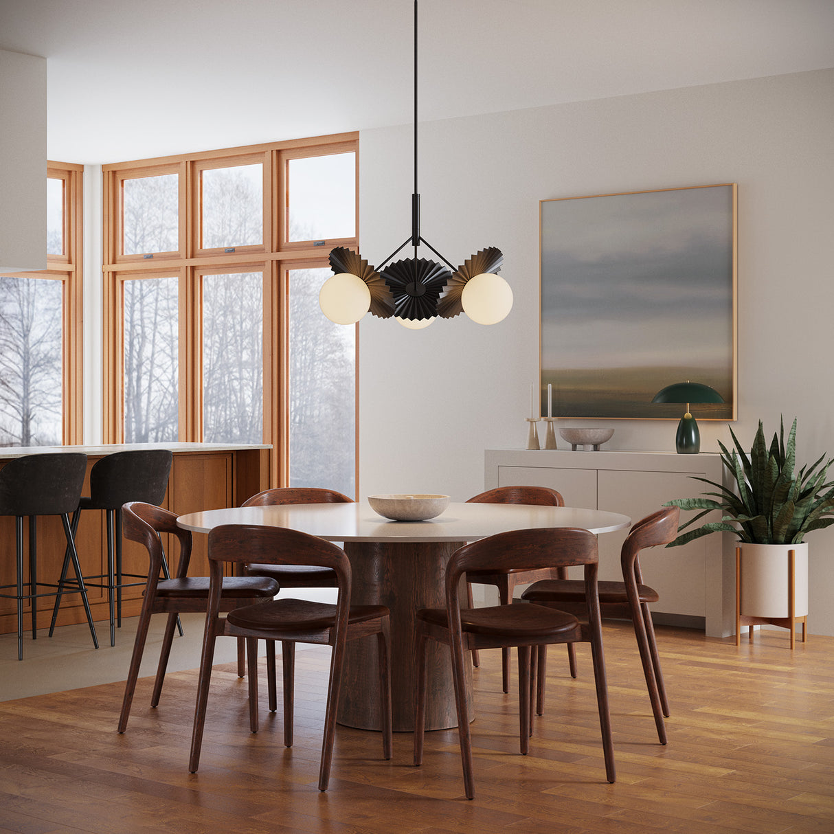 Modern dining room with wooden table and chairs, Lydia 21" three light pendant in black, and large windows.