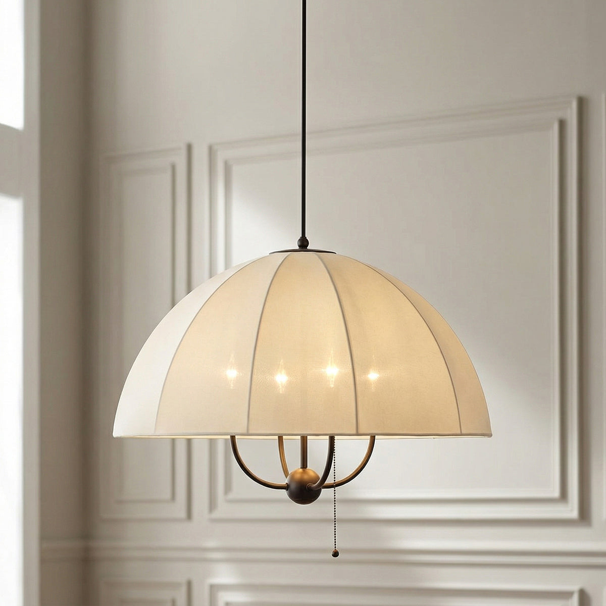 Trudy 4 Light Large Pendant 24", Matte Bronze with Cream Fabric Shade scalloped Pendant in a Transitional Living Room with white wall paneling.
