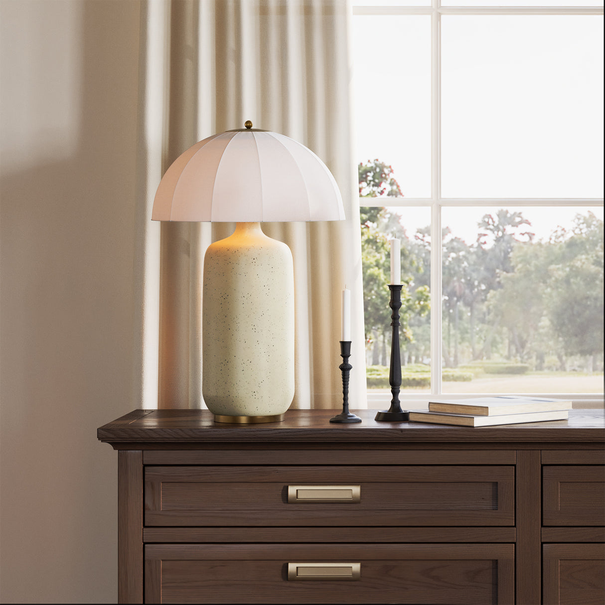 Trudy Table Lamp, Cream with Brass Accents on a wooden dresser with a window in the background