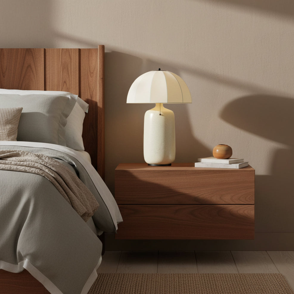 Trudy Table Lamp, Cream with Black Accents - A bedside table lamp beside a bed in a bedroom setting.