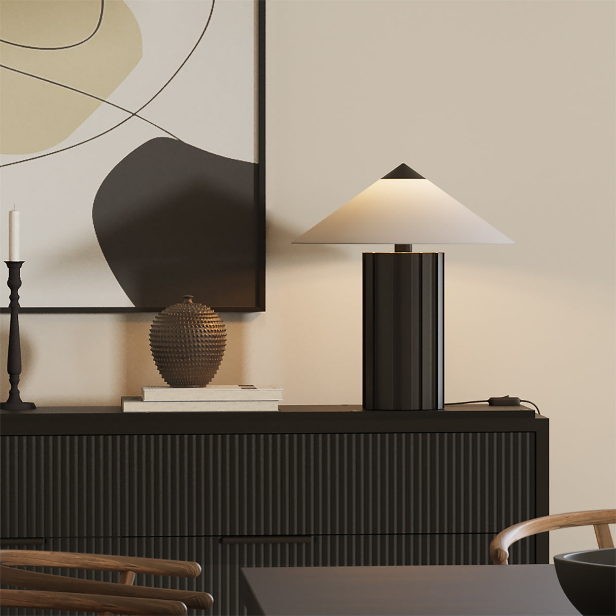 Modern interior with the Lee black table lamp, decorative vase, and abstract wall art.
