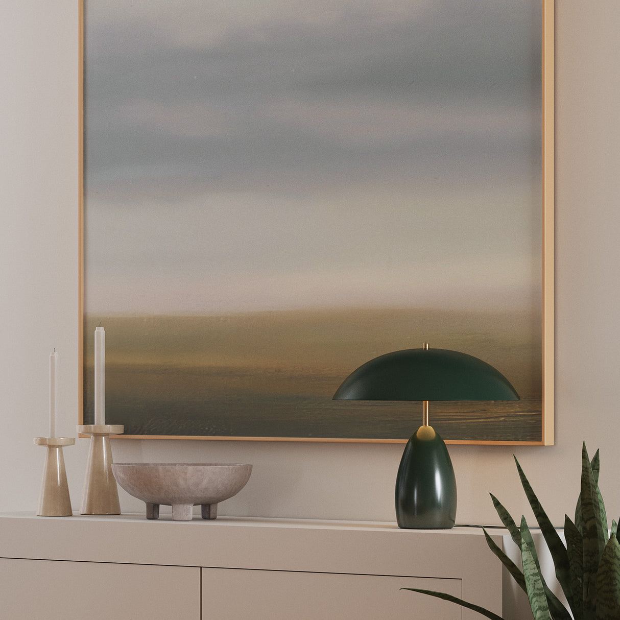 Aubrey LED Table Lamp, in Hunter Green, is showi n on a modern console in front of large abstract art.