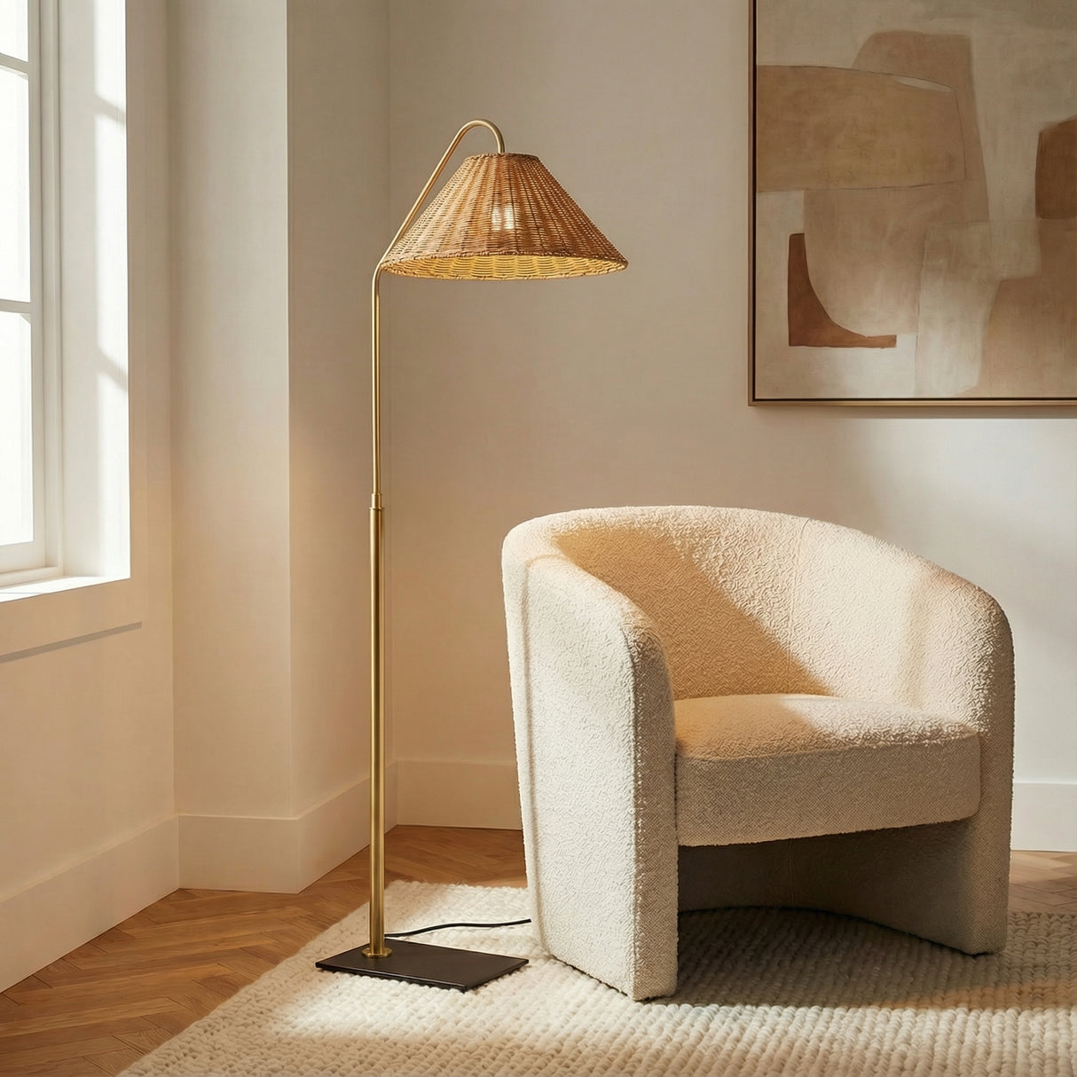 Fiona Floor Lamp, Aged Brass and Rattan woven floor lamp in a Transitional Living Room with a cream bouclé chair.