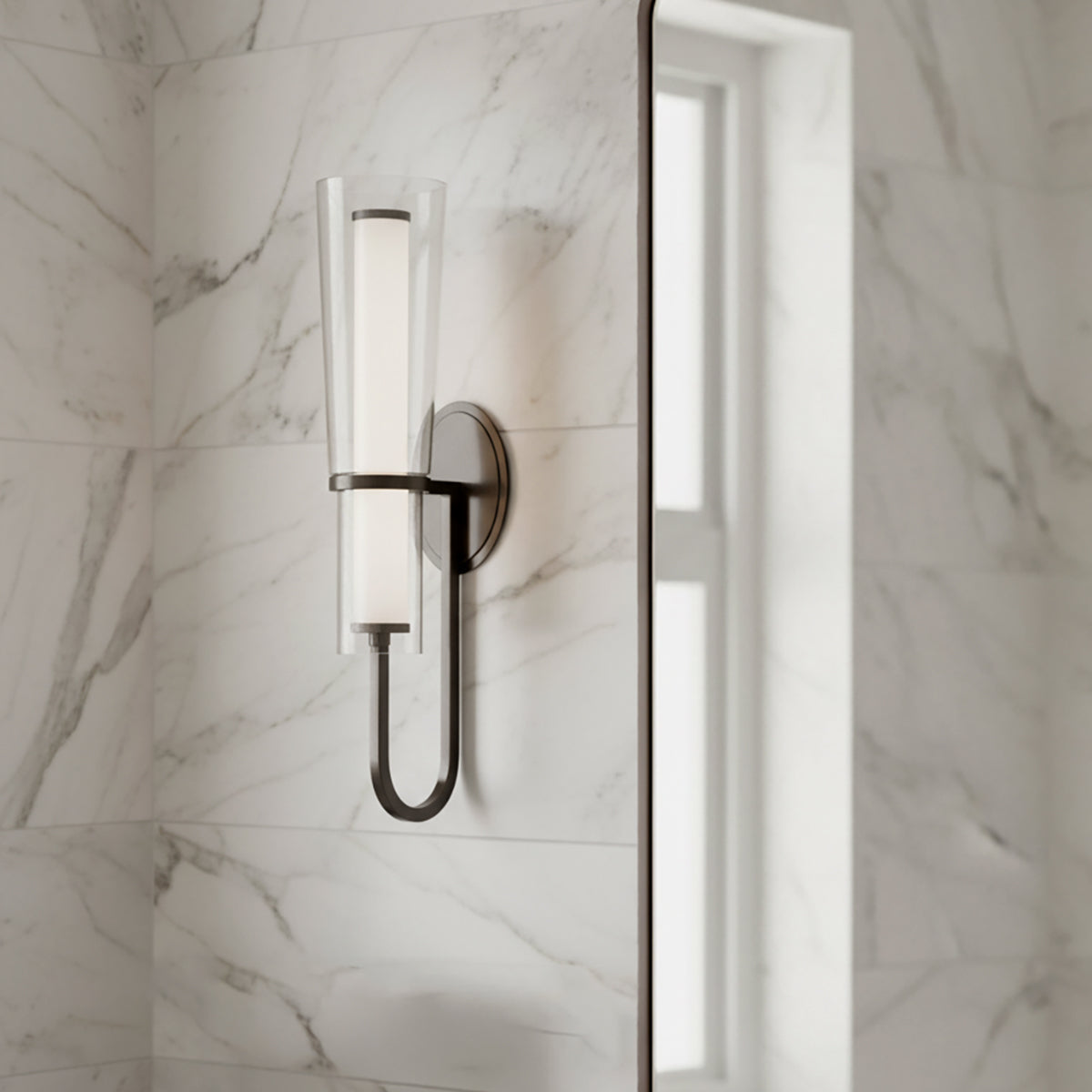 Wall-mounted Clair 20" fixture on a marble wall in a bathroom.