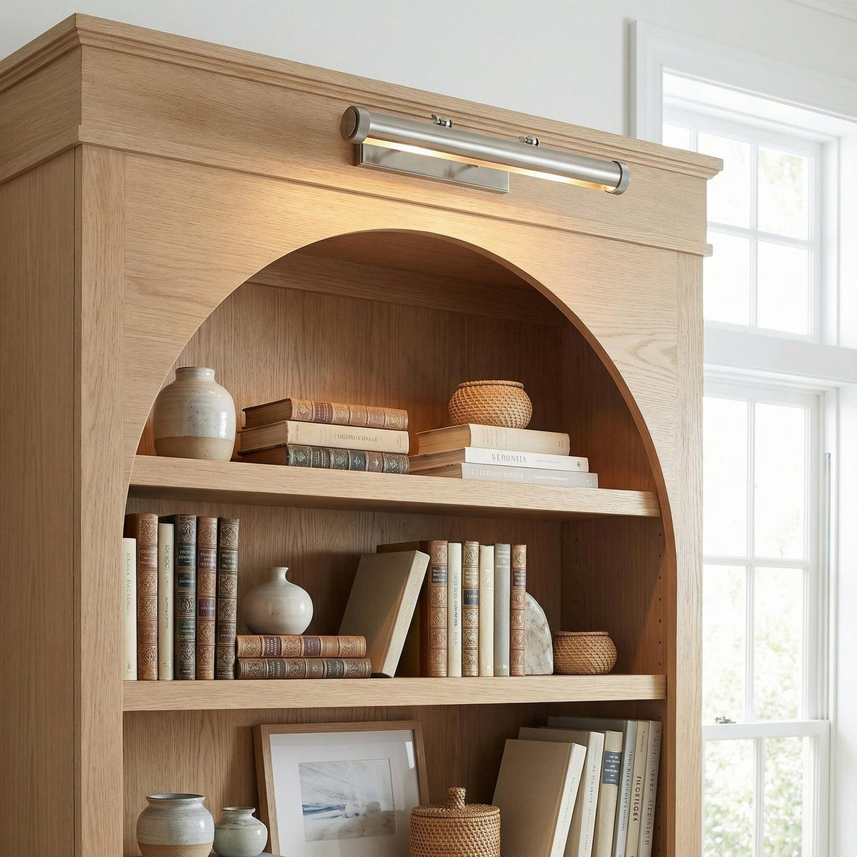 Graham Large Picture Light, Vintage Nickel linear Picture Light in a Transitional Living Room with a natural oak bookcase.