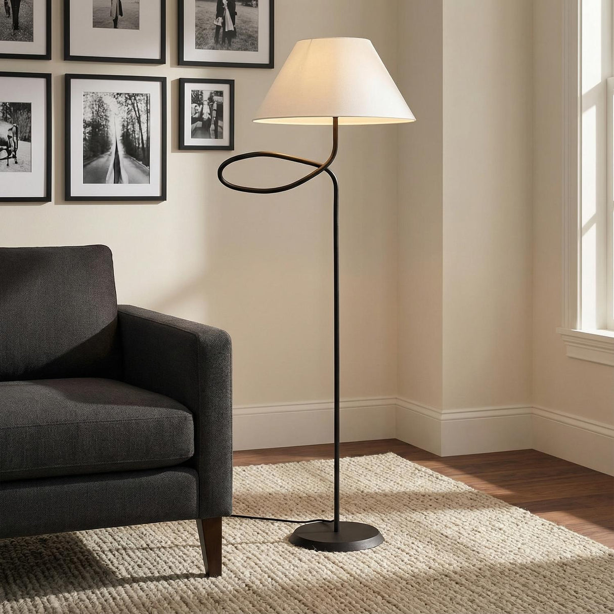 Odin Floor Lamp, Forged Iron styled in a Modern Living Room with dark grey sofa and textured rug.
