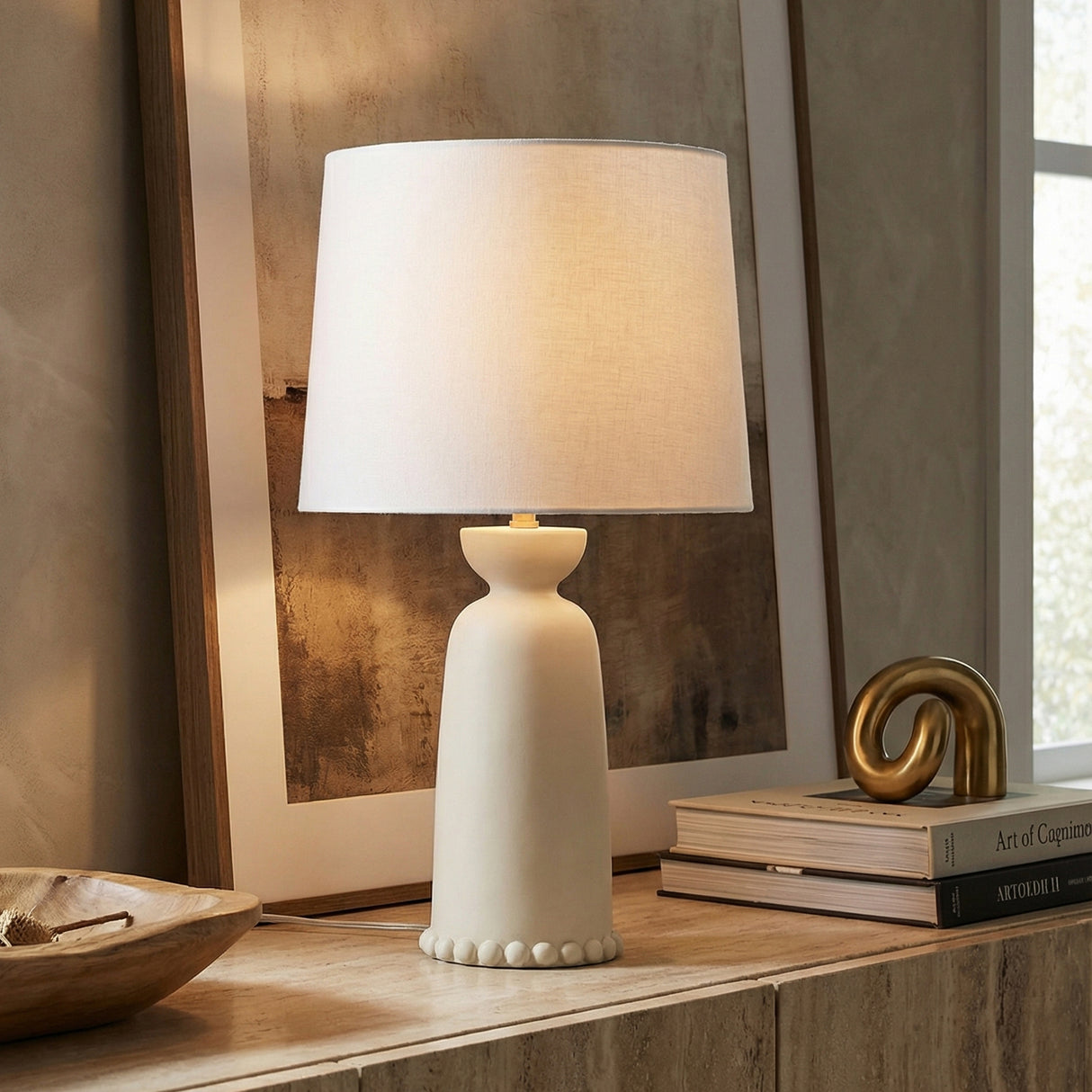 Bonnie Ceramic Table Lamp, Antique Ivory beaded table lamp in a Transitional Living Room with a travertine console table.