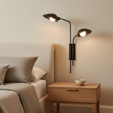 Modern Royce Plug-in Wall Sconce above a wooden nightstand in a bedroom setting.