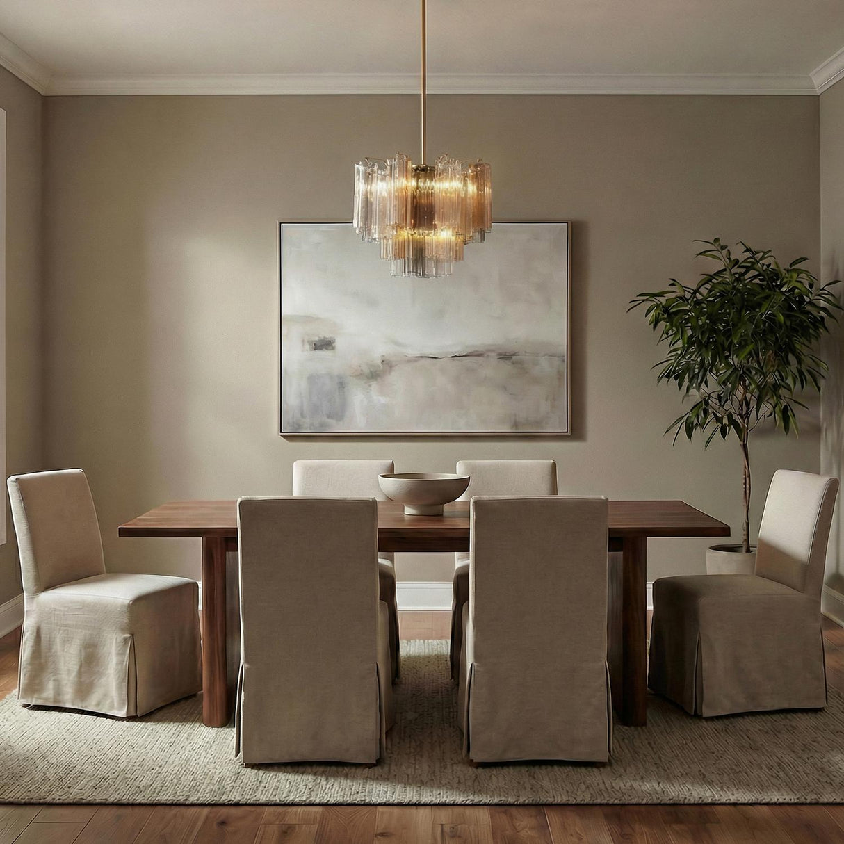 Grace Brass geometric tiered Chandelier in a Contemporary Dining Room with a wooden table and slipcovered chairs.