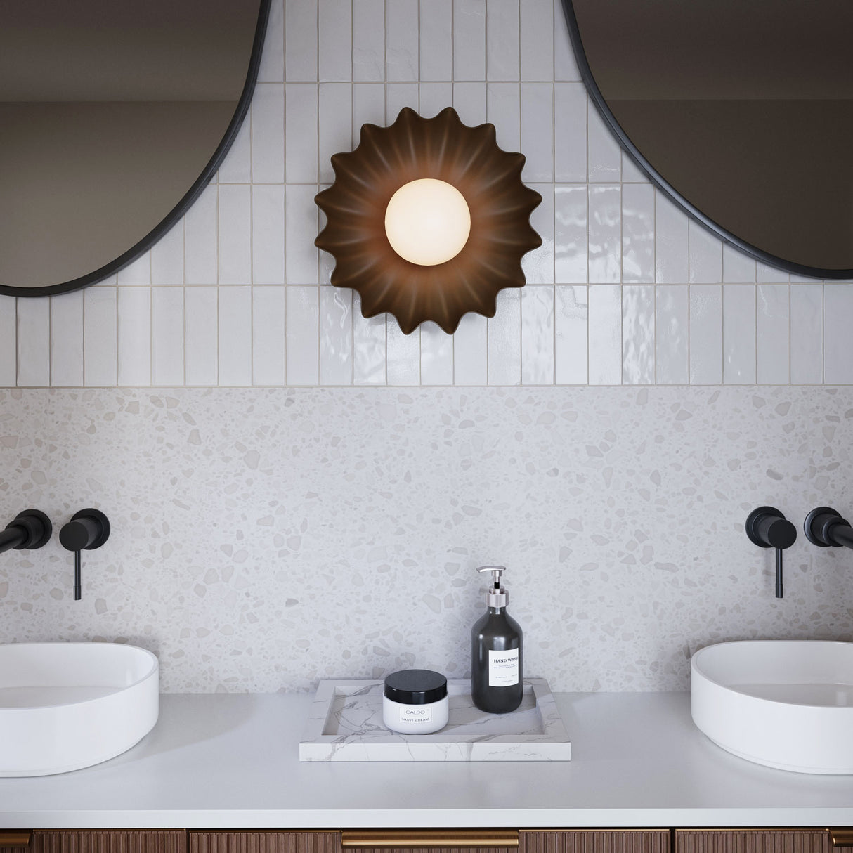 Flare LED Sconce 10", Matte Black finish and Opal Glass, is shown in a contemporary bathroom with white terrazzo backsplash and black faucets.