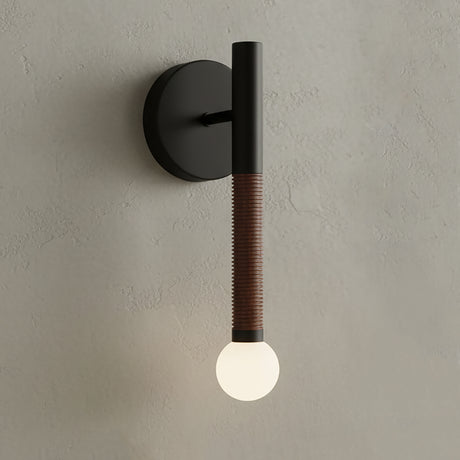 Modern wall light fixture with black and brown design on a neutral wall.