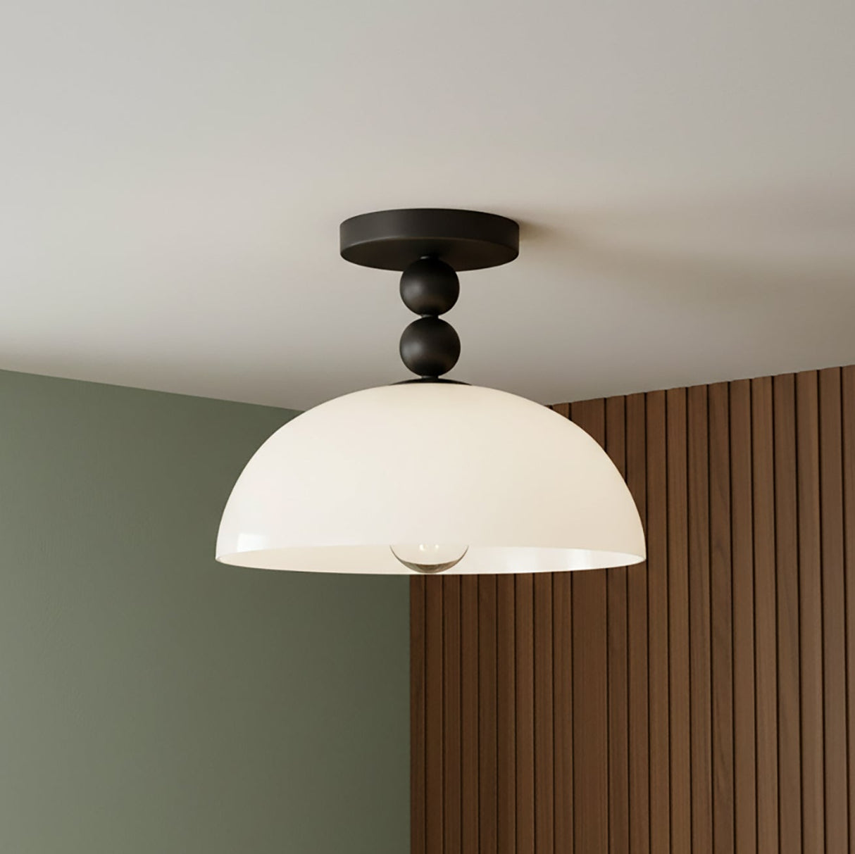 Modern and playful ceiling light with matte black ball accents and white glass shade.