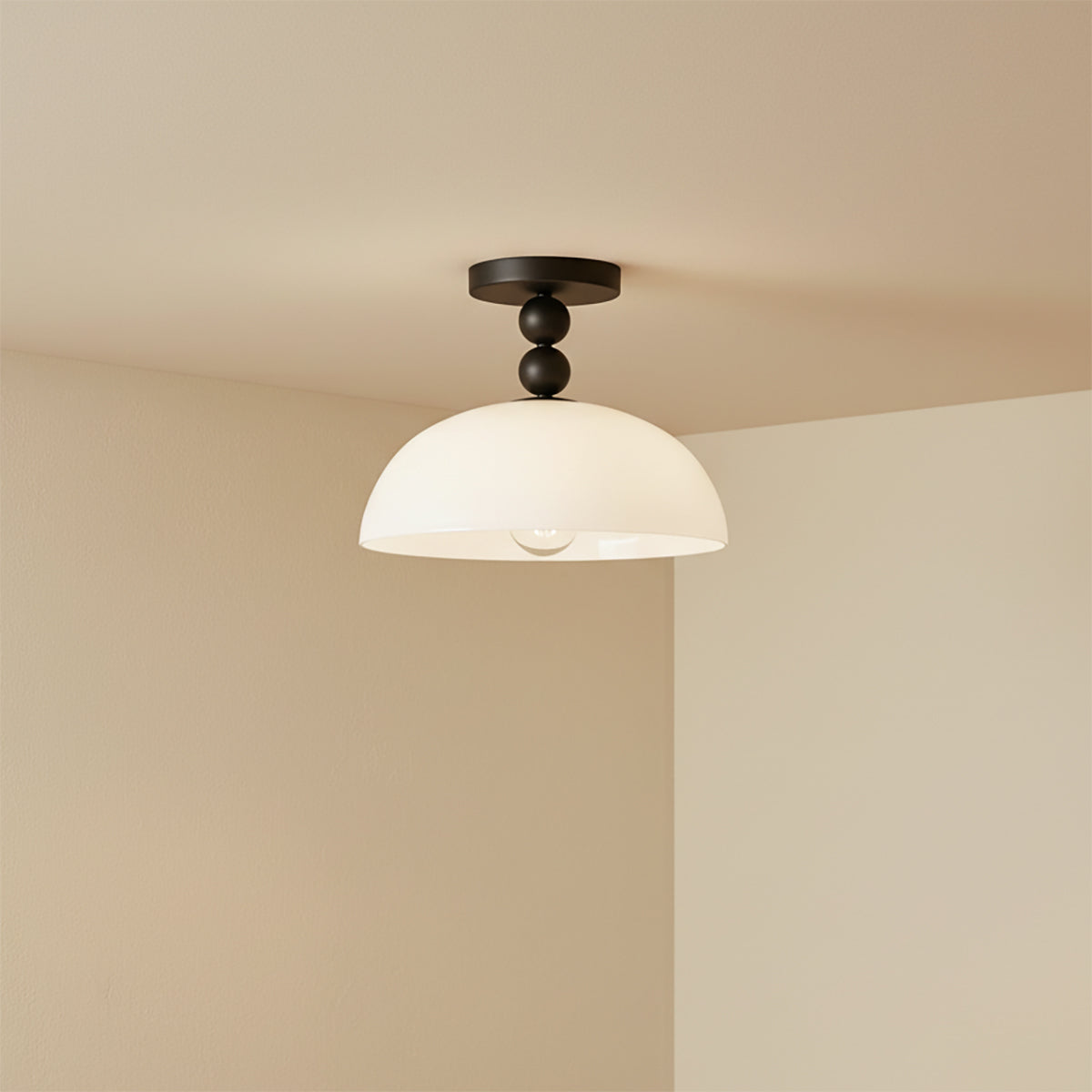 Archie Flush Mount 12, Matte Black and Opal Glass - Flush mount light fixture against a neutral colored wall.