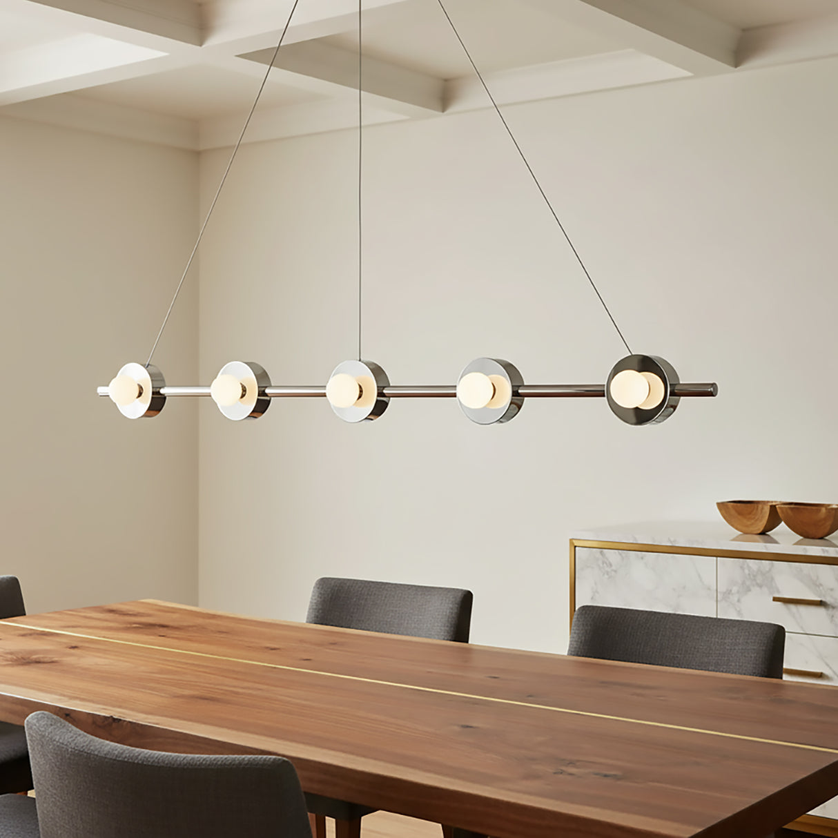 Modern 48" pendant light hanging above a wooden dining table with seating for eight.