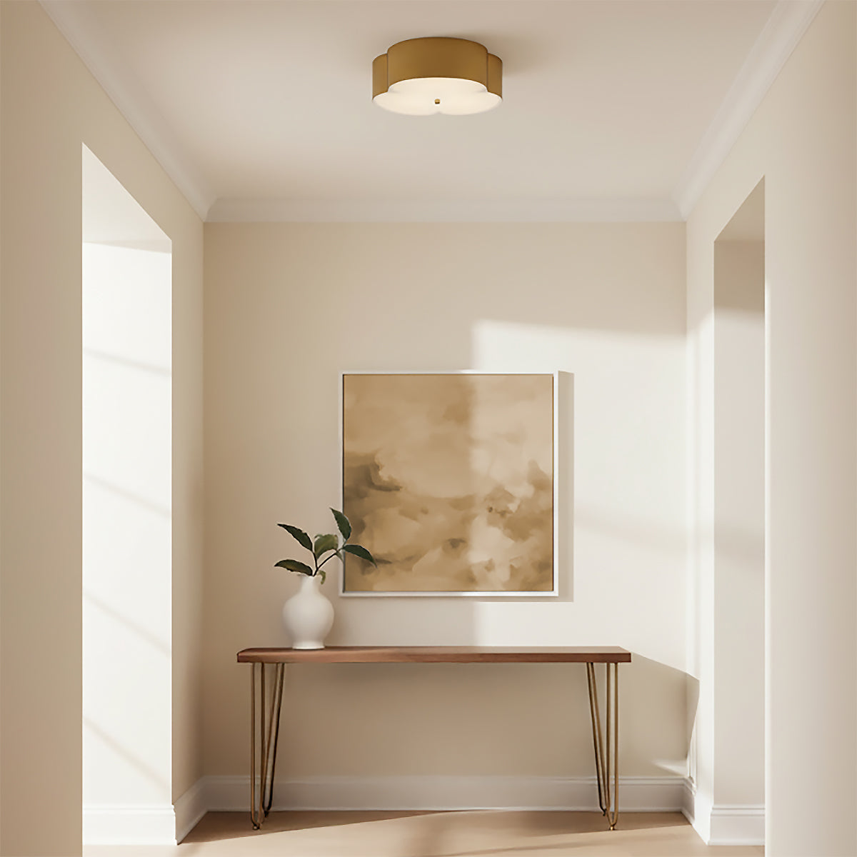 Shyla Flush Mount 14, Brushed Brass - A flush mount light fixture with a scalloped shade illuminates a hallway with a console table and artwork.