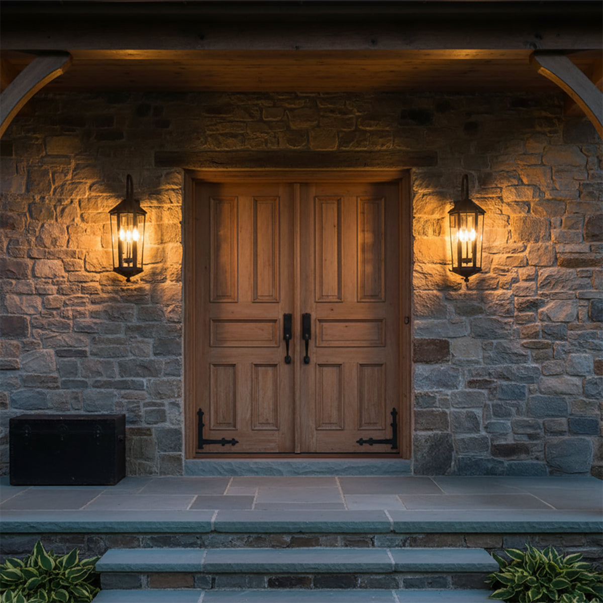 Asbury Outdoor Wall Light, Medium 29" Black - Two black outdoor wall lights illuminate a stone-clad entryway with a double wooden door.