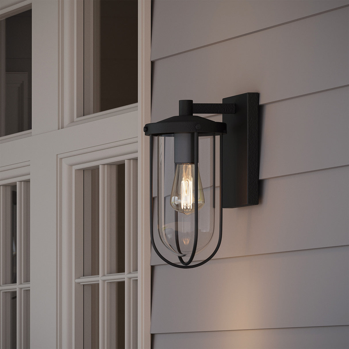 Close-up images of the Orson Outdoor Wall Light, Small 12" with black finish, shown on a grey exterior wall with siding and white trim.