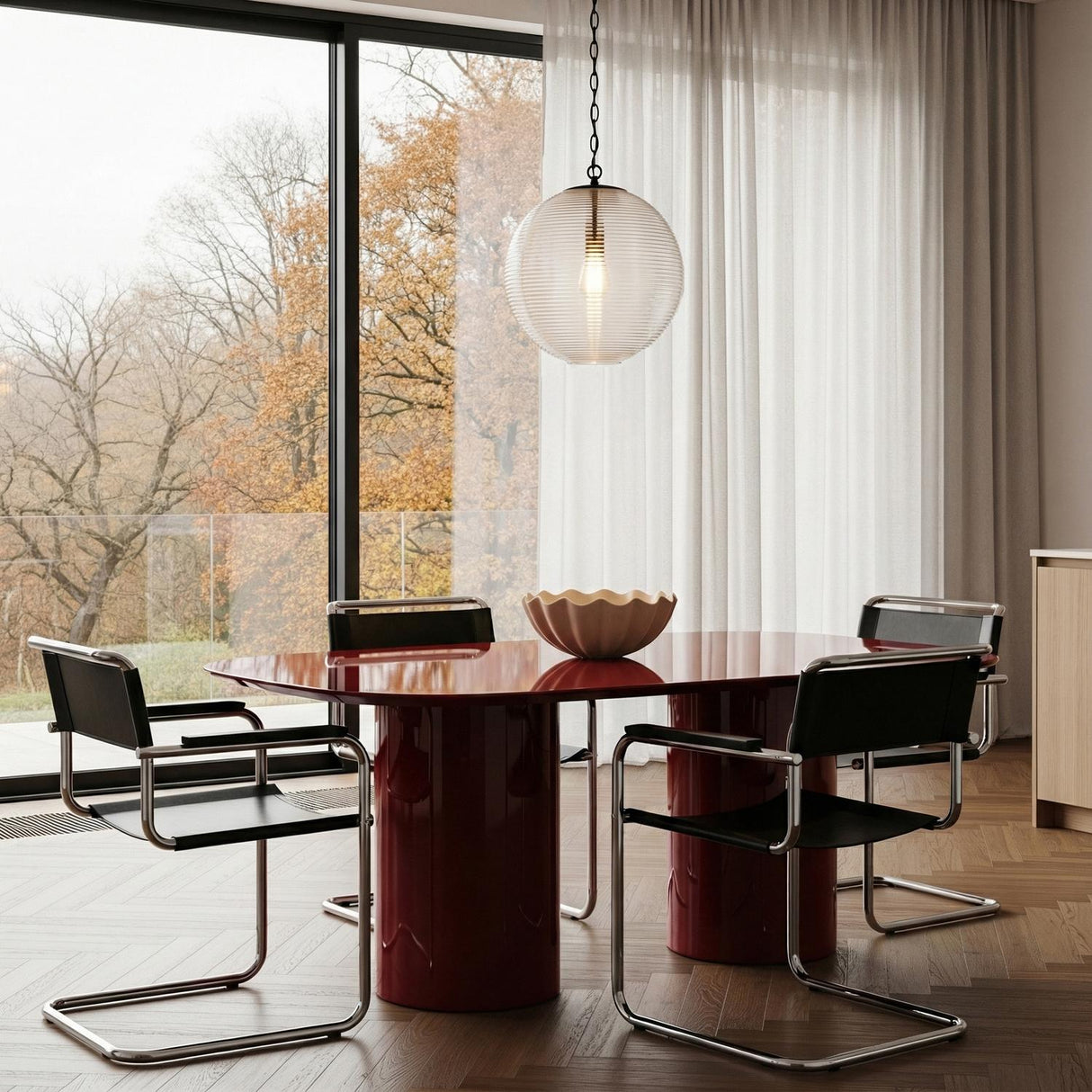 Matte Black globe Pendant in a Modern Dining Room with a high-gloss red dining table & black cantilever chairs.