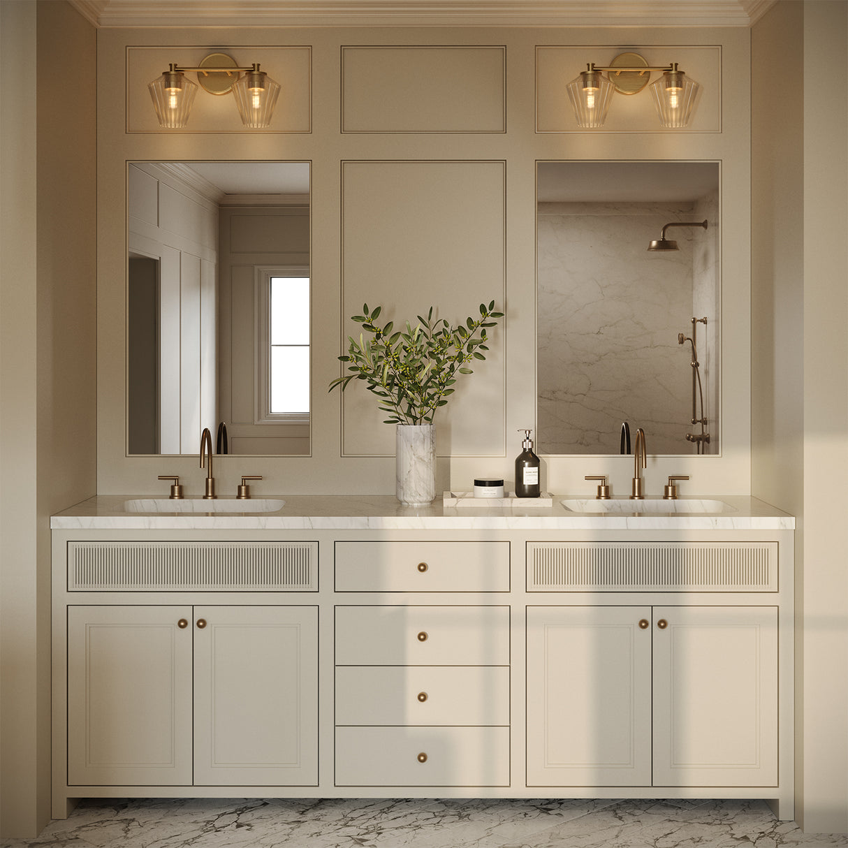 Transitional styled primary bathroom with two sinks and the Sariel 2 light in brass giving a warm glow.