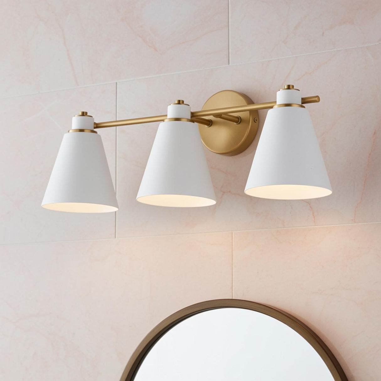 Avin 3 Light Vanity, White and Aged Brass styled in a Modern Bathroom with marble tile.