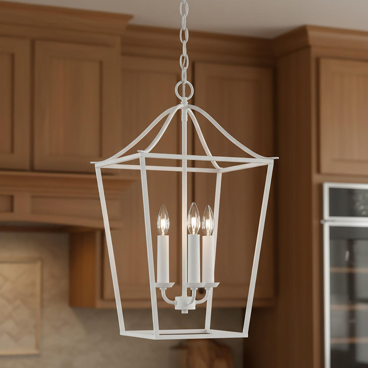 A farmhouse kitchen featuring the Eloise Lantern Pendant 16", Textured White in a textured white finish suspended from the ceiling center against warm wood shaker cabinets.