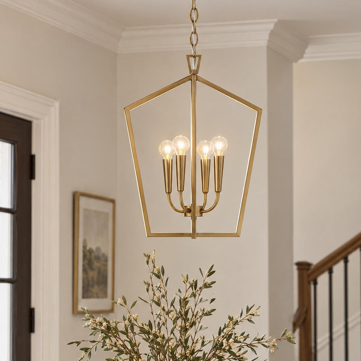 A transitional foyer with an aged brass lantern pendant suspended near a dark wood paneled door, neutral walls with crown molding, and a staircase.