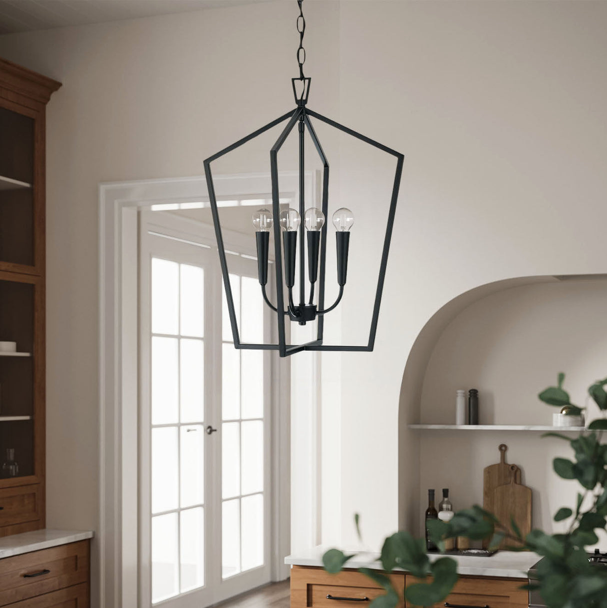 Black pendant light fixture hanging in a kitchen with wooden cabinets and a white door.