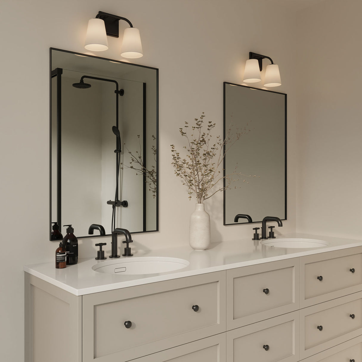 Double vanity with black hardware and rectangular mirrors, feature the Brier 2 Light 14.5" wide Vanity Light in matte black above each mirror.