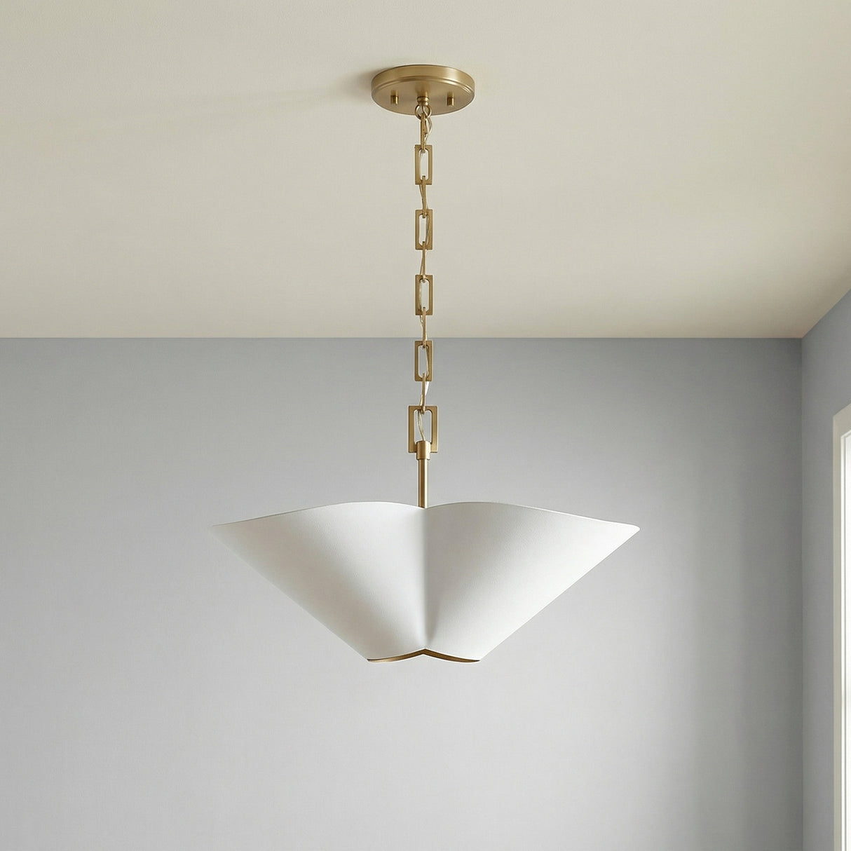 White and Matte Brass geometric pendant in a Contemporary Living Room with light grey walls.