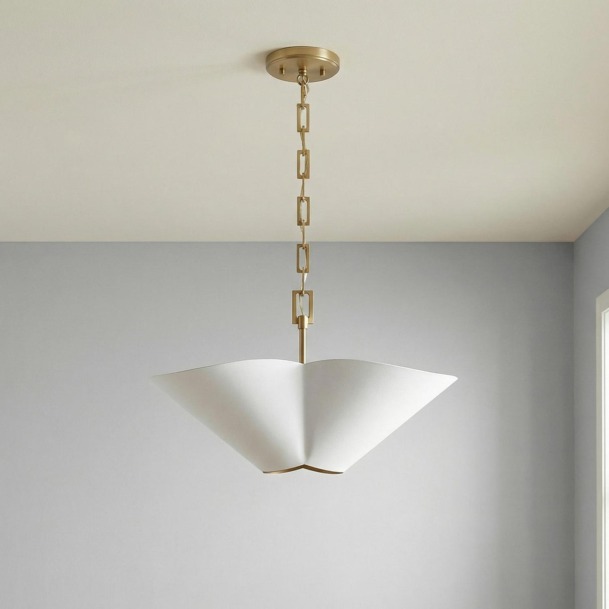 White and Matte Brass geometric pendant in a Contemporary Living Room with light grey walls.