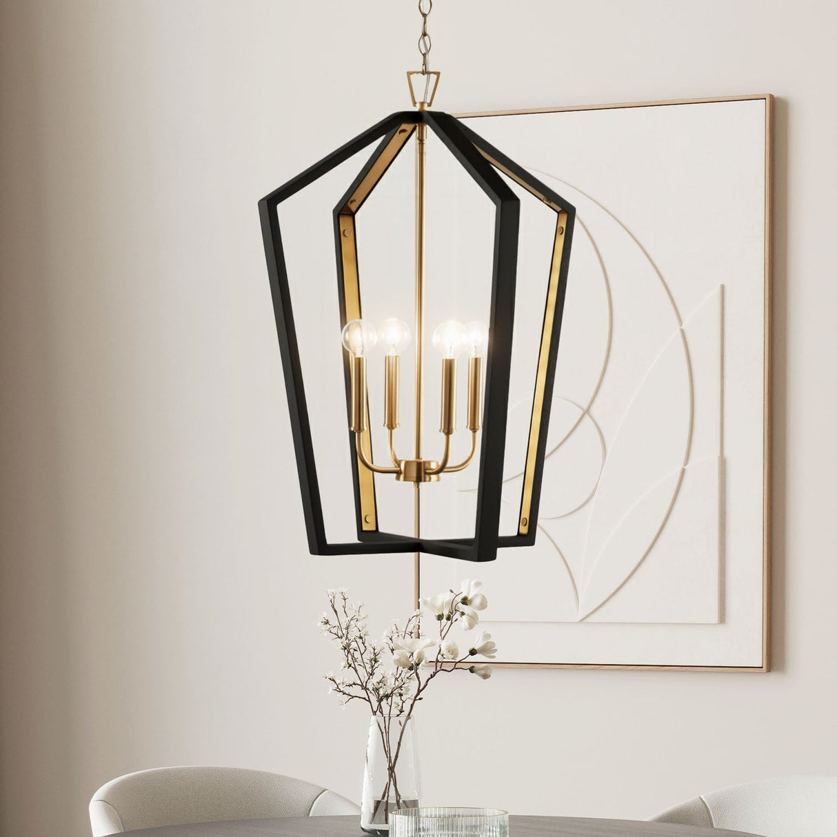 Talin Lantern Pendant 20", in Black Wood and Matte Brass finish is shown in front of modern art, in a dining room.