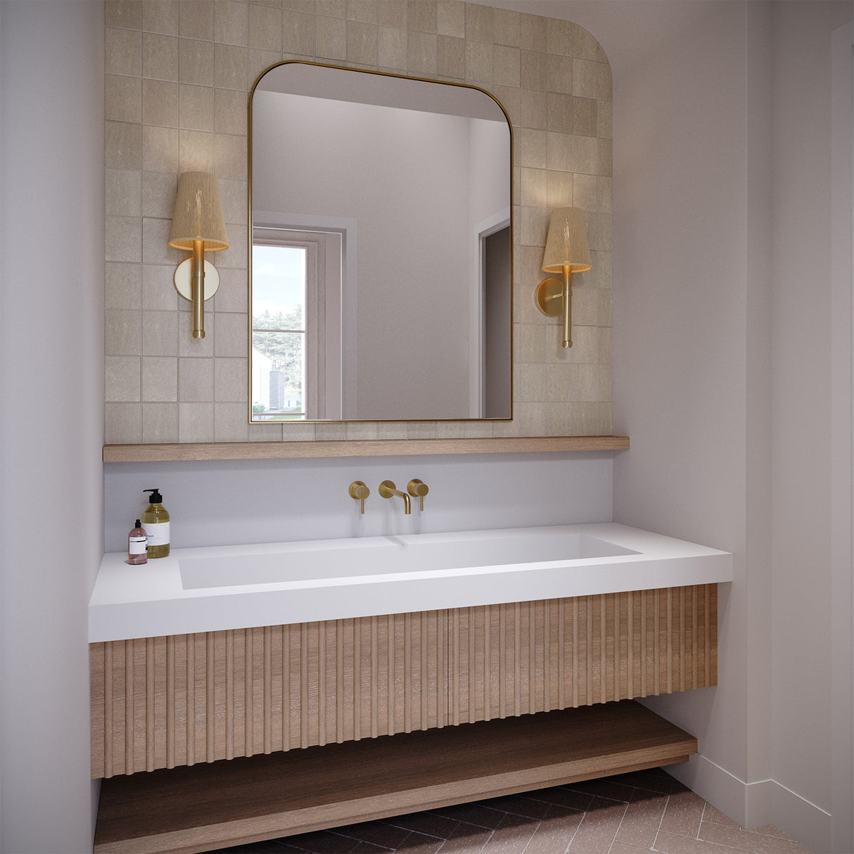 Two 17" tall Evren Wall Sconces shown in a contemporary bathroom flanking an arched mirror, above a large white stone sink and light wood floating vanity.