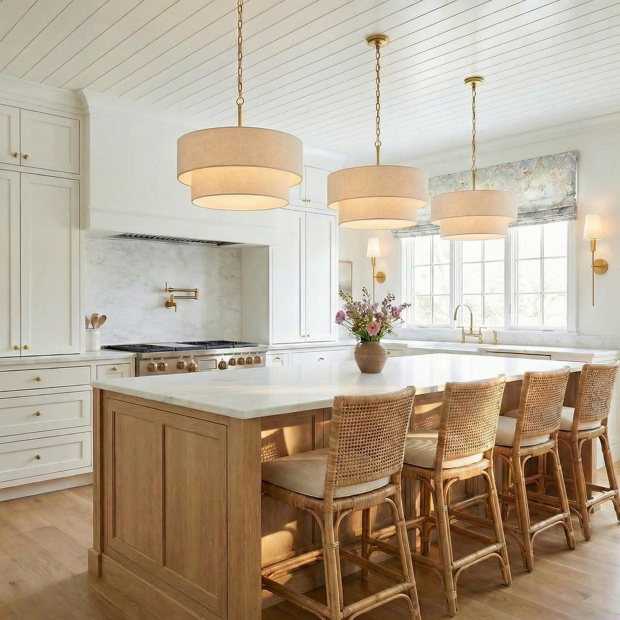 Tiered Linen Pendant, Matte Brass geometric design Pendant in a Transitional Kitchen with white marble island and woven stools.