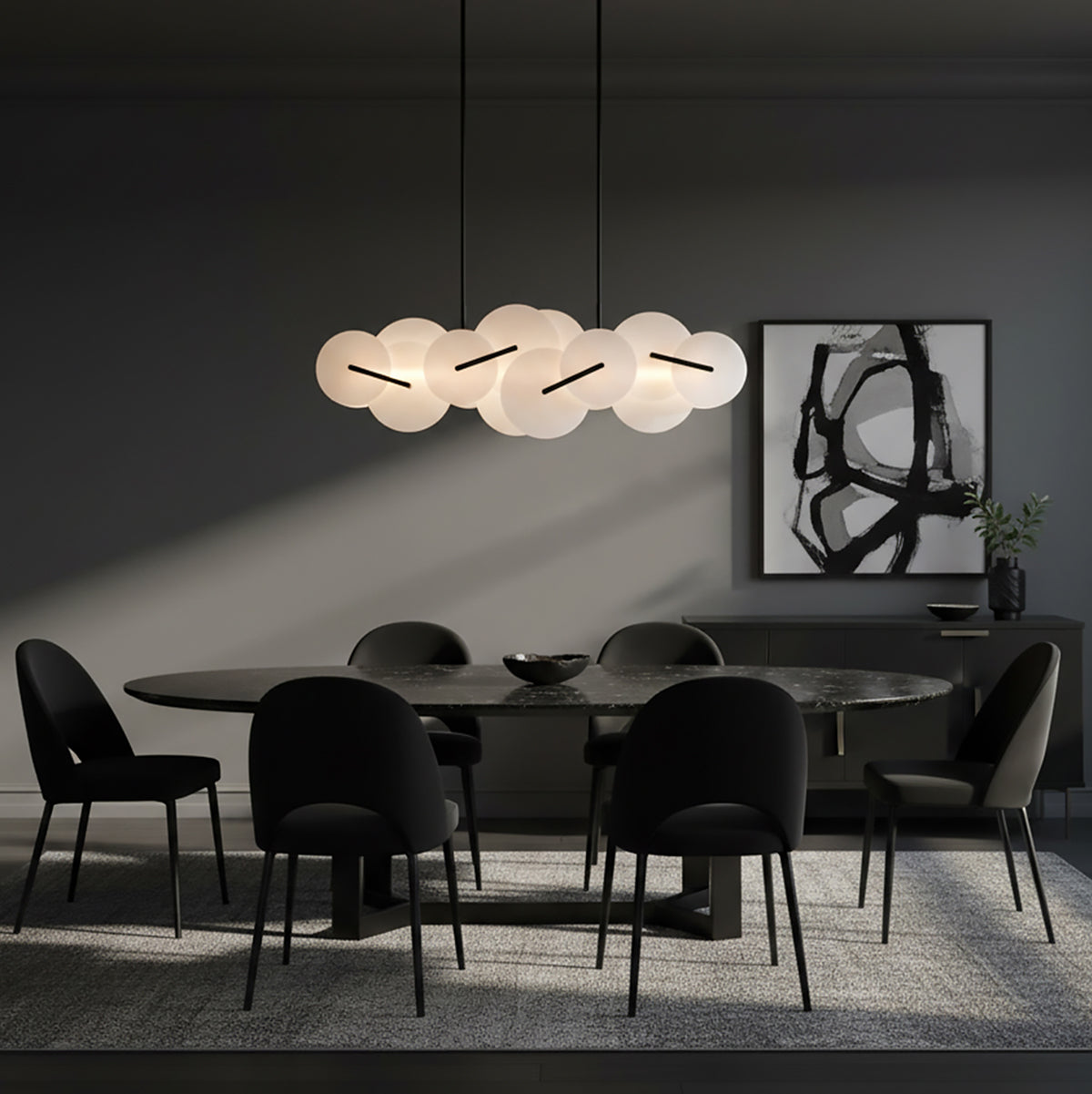 Malya LED Linear Chandelier 56, Matte Black with Opal Glass - A modern dining room with an oval marble table, black chairs, a dark sideboard with artwork and a modern chandelier.